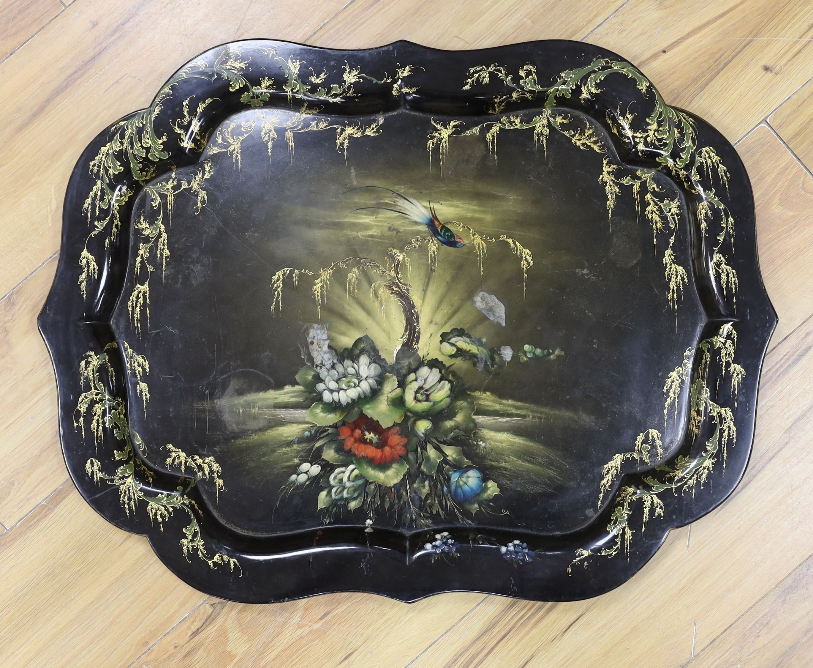 A Victorian floral and gilt painted shaped papier mache tray, 64 cms wide.